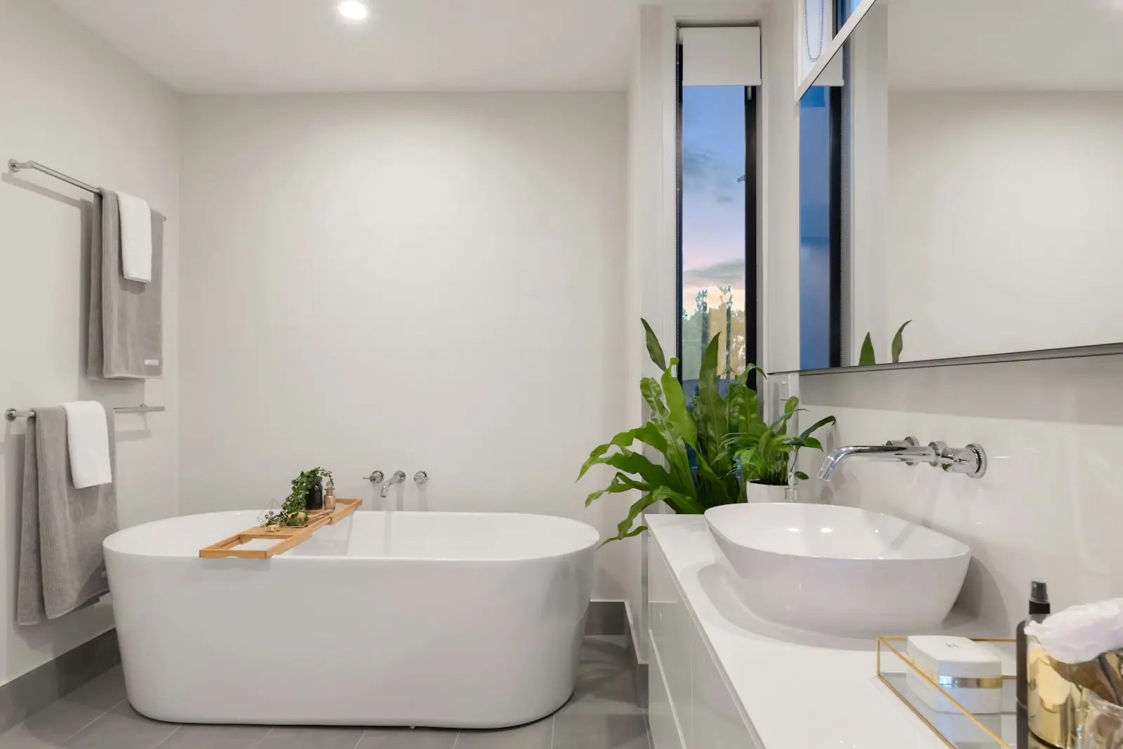 Bright renovated bathroom with a freestanding bath and stone basin